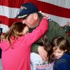 Captain Hurst hugs his children and wife following the change of command ceremony.